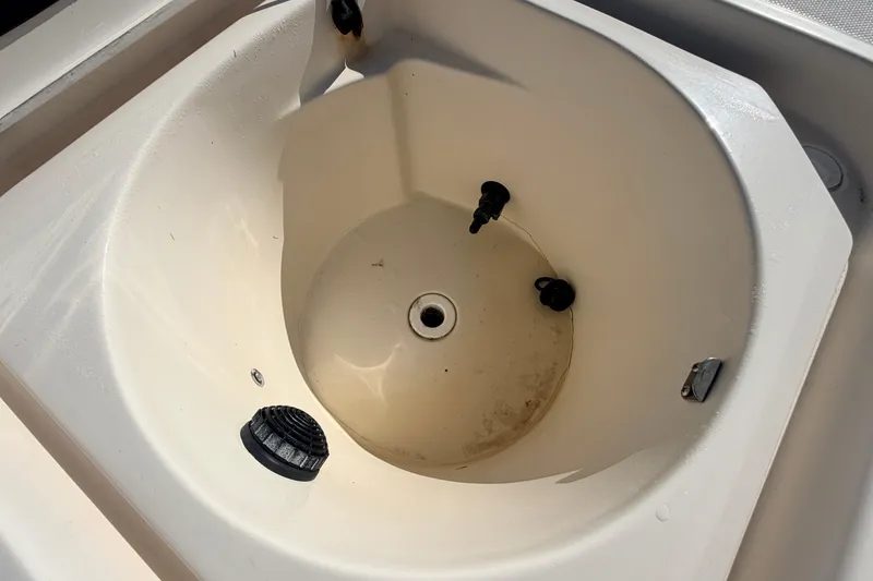 Slide: The Image of Canyon Bay 24H 2010 boat livewell interior with drain and fittings. - 75