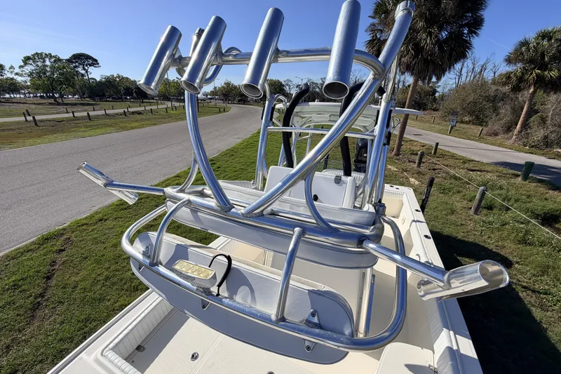 Slide: The Image of 2010 Canyon Bay 24H boat with rod holders, parked near a scenic road. - 78