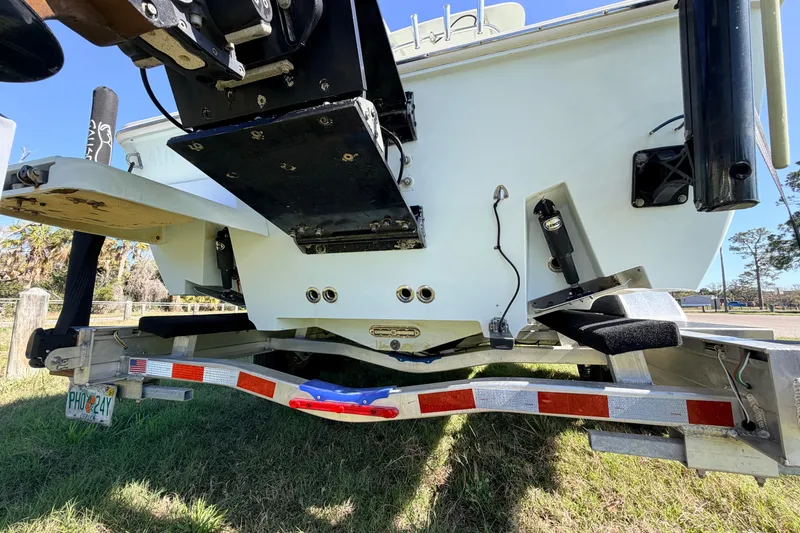 Slide: The Image of Rear view of a 2010 Canyon Bay 24H boat on a trailer, showcasing its hull and components. - 8