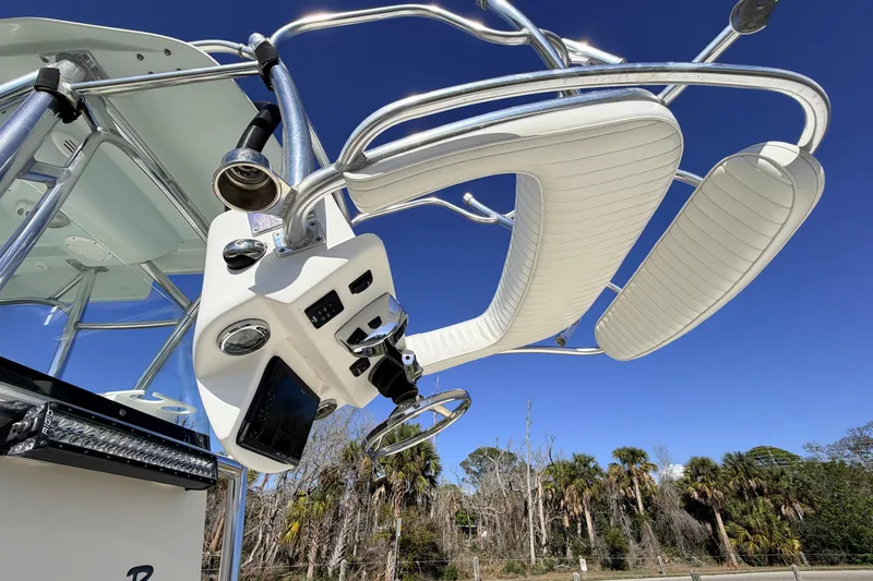 Slide: The Image of Canyon Bay 24H boat helm with white seating and controls, 2010 model. - 80