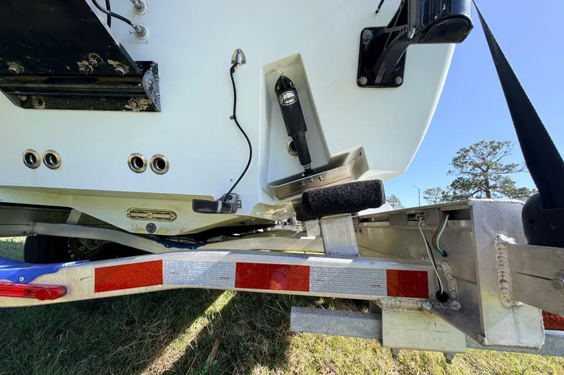 Slide: The Image of 2010 Canyon Bay 24H boat on trailer, showing rear hull and trim tabs. - 83