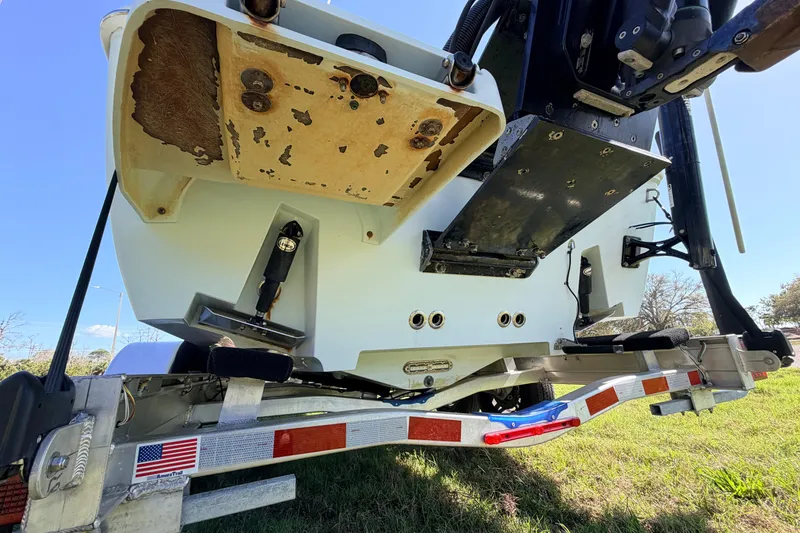Slide: The Image of 2010 Canyon Bay 24H boat on trailer, showing underside and motor mount details. - 86