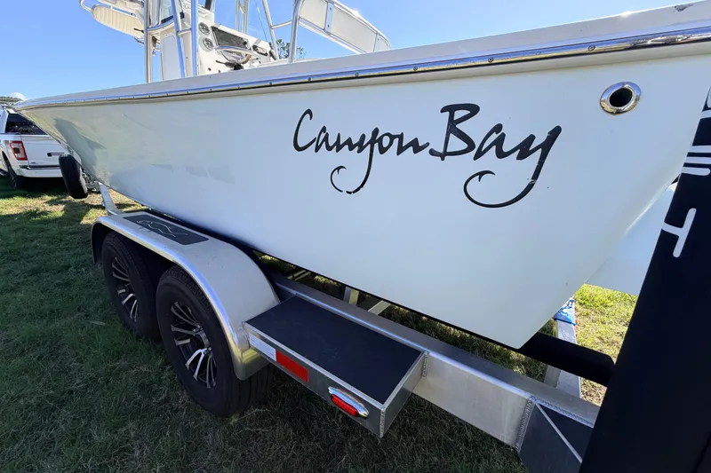 Slide: The Image of 2010 Canyon Bay 24H boat on trailer, side view with logo visible. - 89