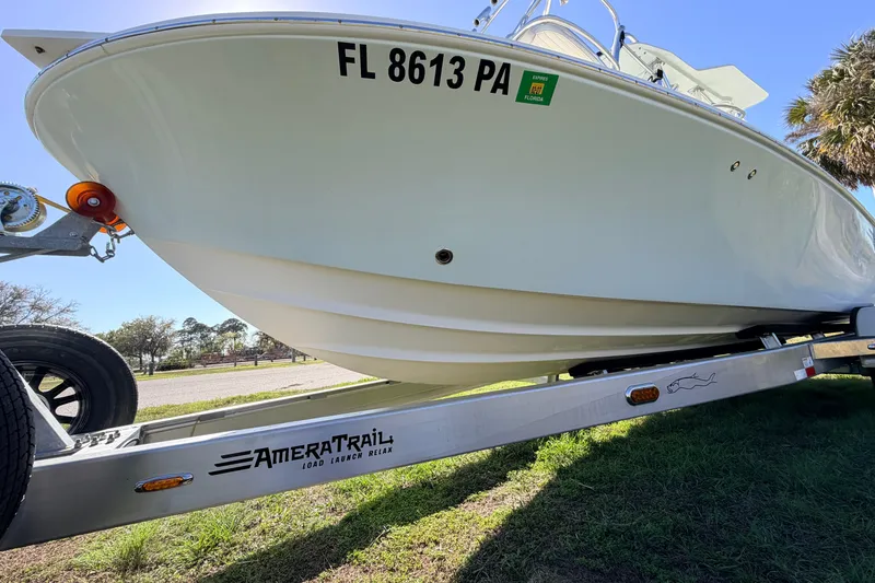 Slide: The Image of 2010 Canyon Bay 24H boat on AmeraTrail trailer, parked on grass. - 90