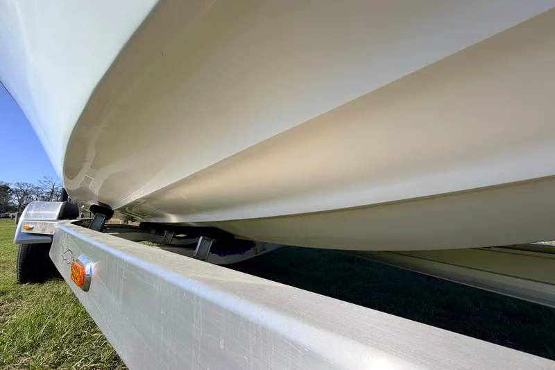 Slide: The Image of Close-up of 2010 Canyon Bay 24H boat hull on trailer, grassy background. - 93