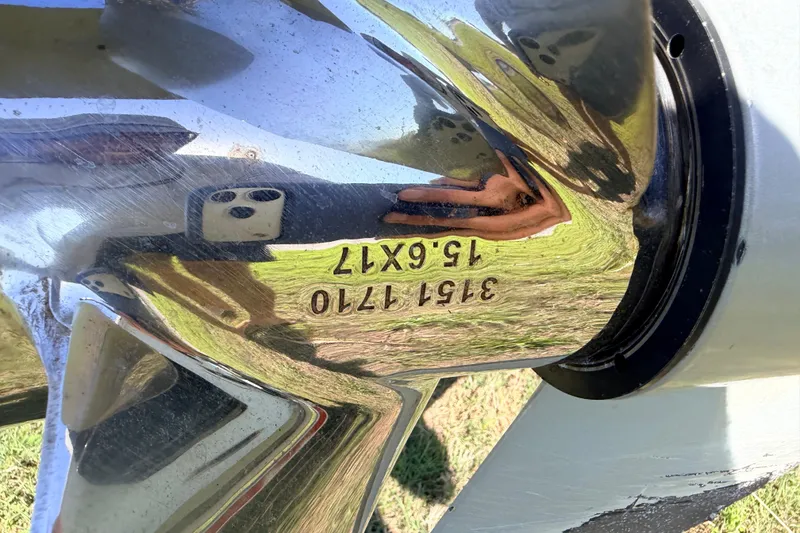 Slide: The Image of Close-up of a polished boat propeller with engraved numbers, reflecting surroundings. - 96