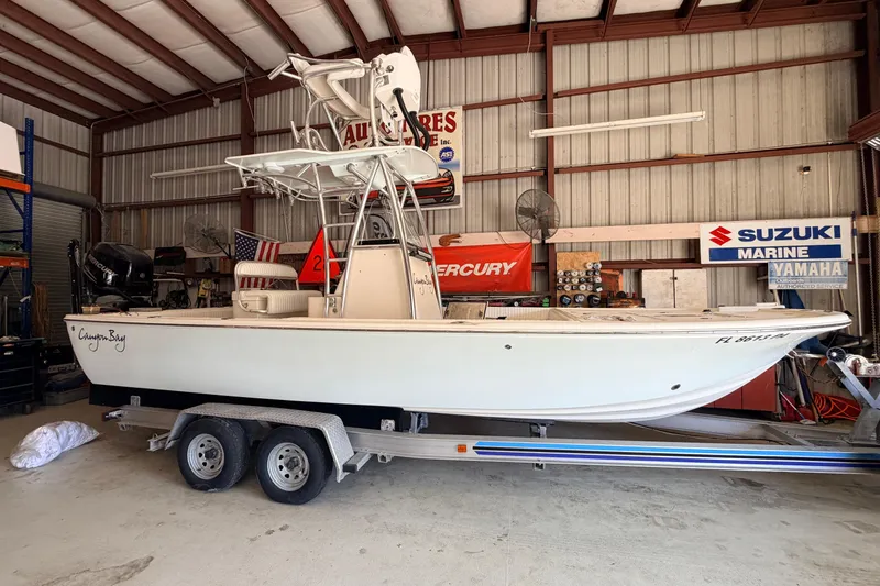 Slide: The Image of 2010 Canyon Bay 24H boat on trailer in a garage with marine equipment. - 99