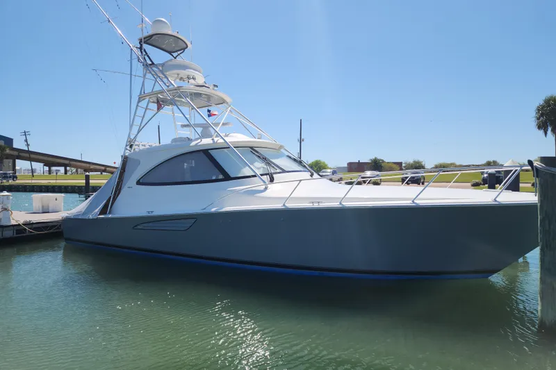 The Image of 2018 Viking 48 Sport Tower yacht docked in sunny marina. - 0