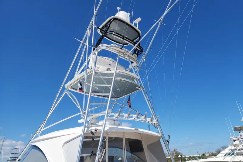 Slide: The Image of 2018 Viking 48 Sport Tower yacht with tall tower against clear blue sky. - 102