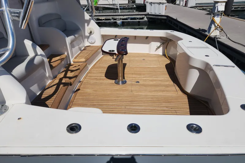 Slide: The Image of Spacious deck of 2018 Viking 48 Sport Tower with wooden flooring and seating. - 103