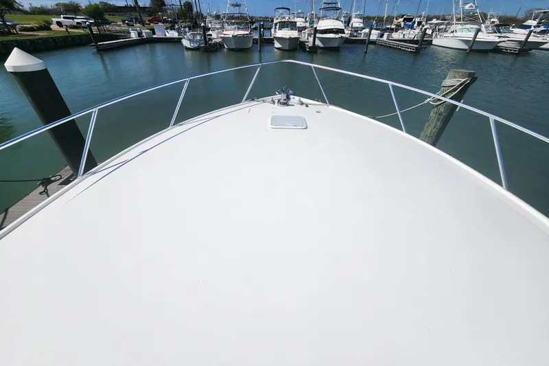 Slide: The Image of Bow view of 2018 Viking 48 Sport Tower docked in a marina. - 105