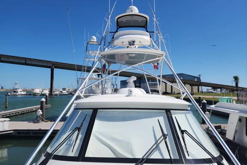 Slide: The Image of 2018 Viking 48 Sport Tower yacht docked at marina under clear blue sky. - 108