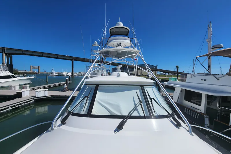 Slide: The Image of 2018 Viking 48 Sport Tower yacht docked at marina under clear blue sky. - 110