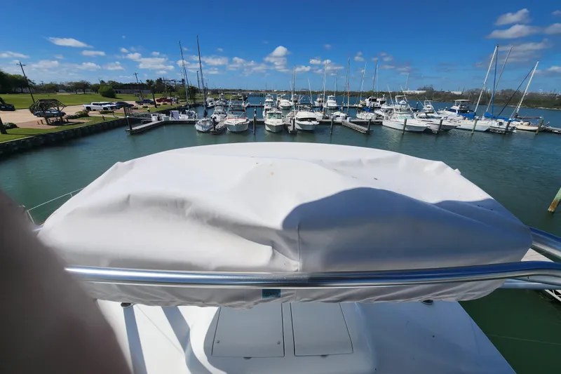 Slide: The Image of Marina view from 2018 Viking 48 Sport Tower, showcasing docked boats under a clear blue sky. - 113