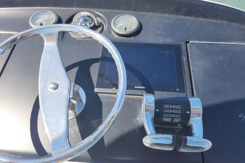 Slide: The Image of Steering console of 2018 Viking 48 Sport Tower with Garmin display and controls. - 119