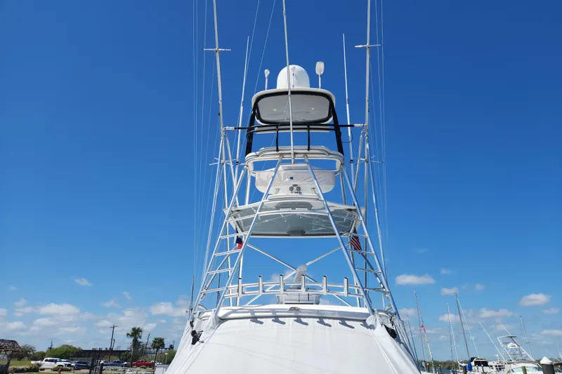 Slide: The Image of 2018 Viking 48 Sport Tower yacht against clear blue sky. - 12