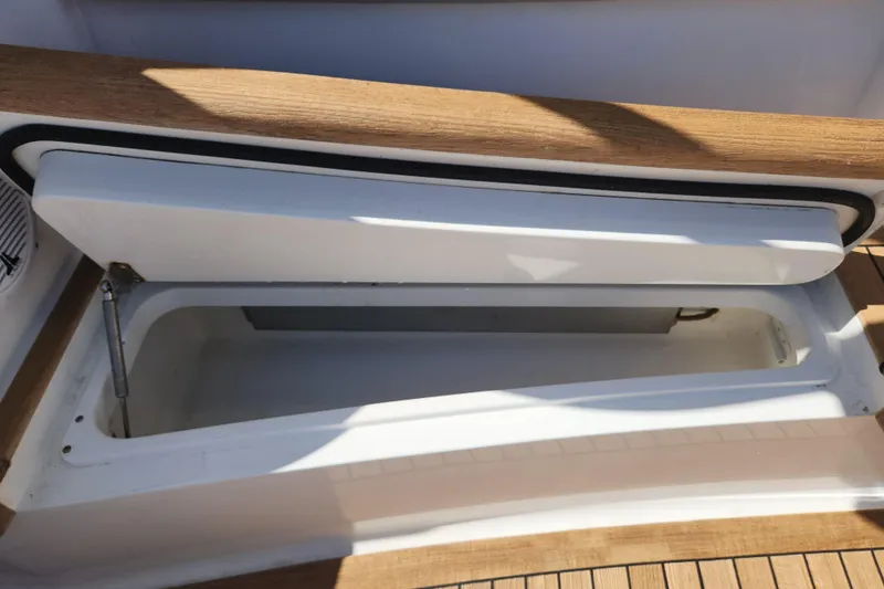 Slide: The Image of Open storage compartment on 2018 Viking 48 Sport Tower boat deck. - 121