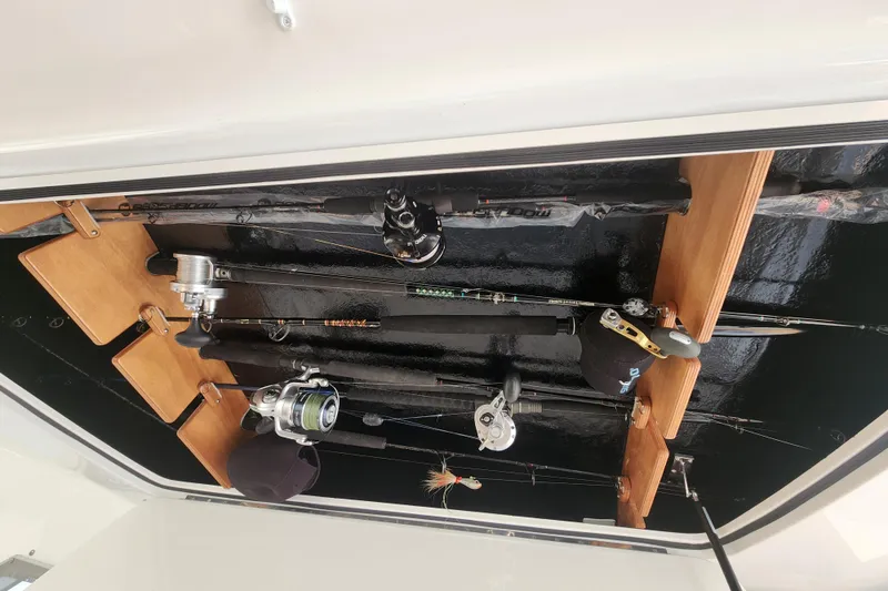 Slide: The Image of Fishing rods stored on a 2018 Viking 48 Sport Tower boat's ceiling rack. - 125