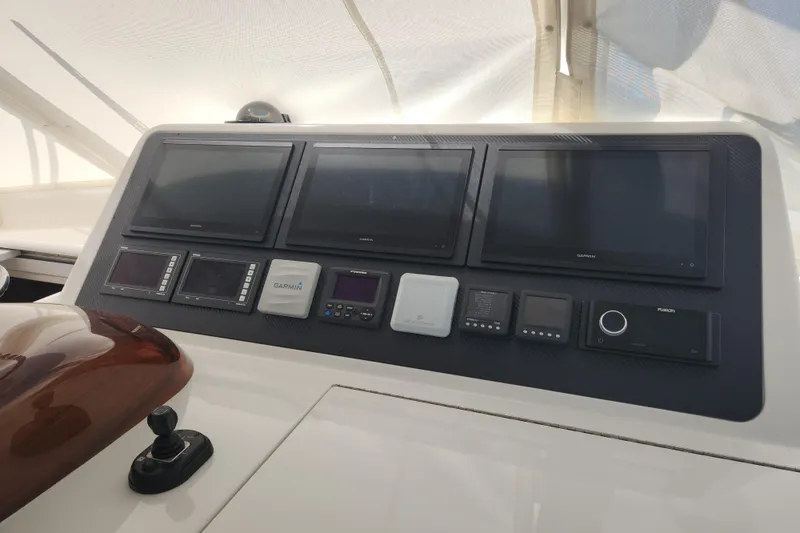 Slide: The Image of Control panel of 2018 Viking 48 Sport Tower with multiple Garmin displays. - 13
