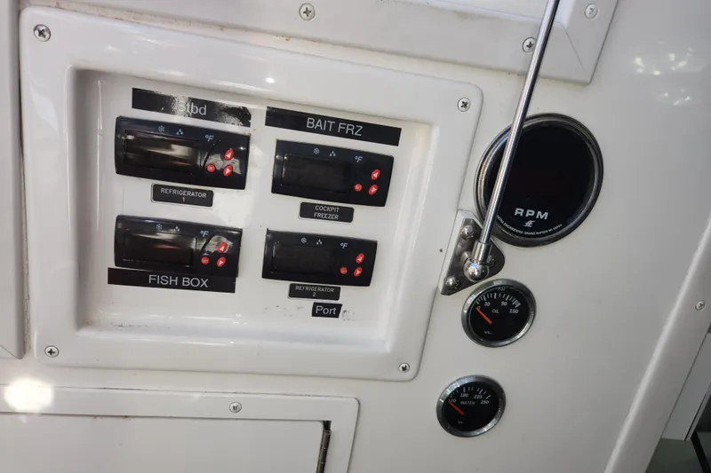 Slide: The Image of Control panel of a 2018 Viking 48 Sport Tower with temperature and RPM gauges. - 132