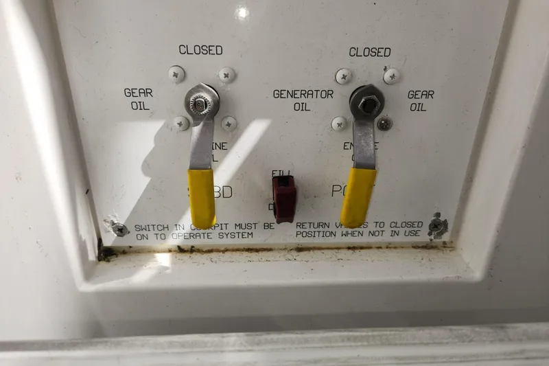 Slide: The Image of Control panel with gear and generator oil levers on a 2018 Viking 48 Sport Tower. - 135