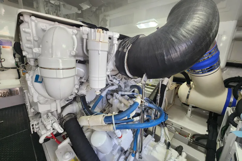 Slide: The Image of Engine room of 2018 Viking 48 Sport Tower, showcasing complex machinery and piping. - 138