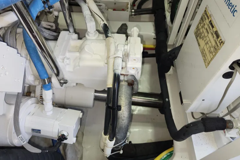 Slide: The Image of Engine compartment of a 2018 Viking 48 Sport Tower, showcasing mechanical components and wiring. - 139