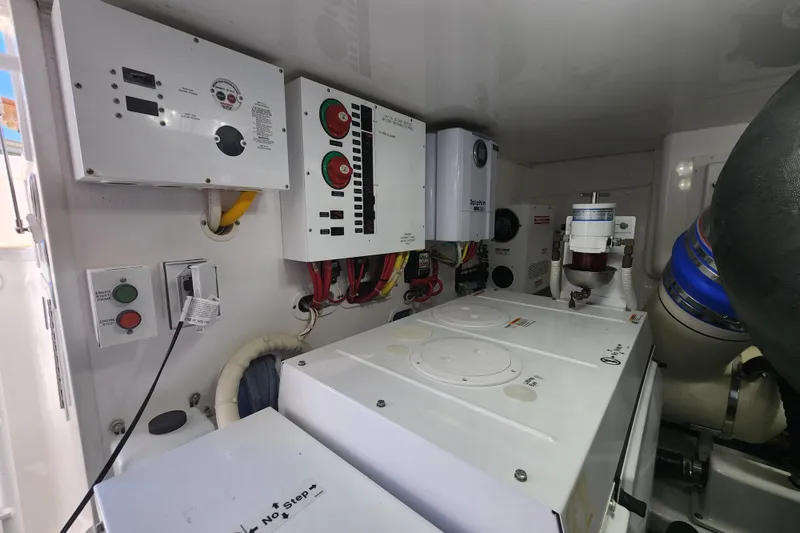 Slide: The Image of Engine room of 2018 Viking 48 Sport Tower with control panels and machinery. - 142