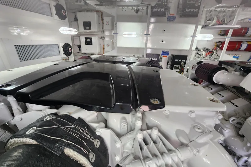 Slide: The Image of Engine room of a 2018 Viking 48 Sport Tower yacht, showcasing mechanical components. - 143