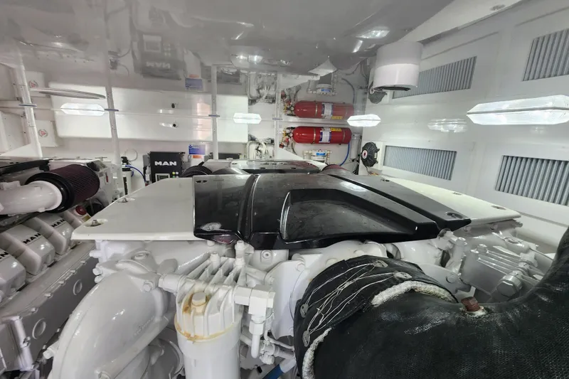 Slide: The Image of Engine room of a 2018 Viking 48 Sport Tower yacht, featuring MAN engines and fire extinguishers. - 144