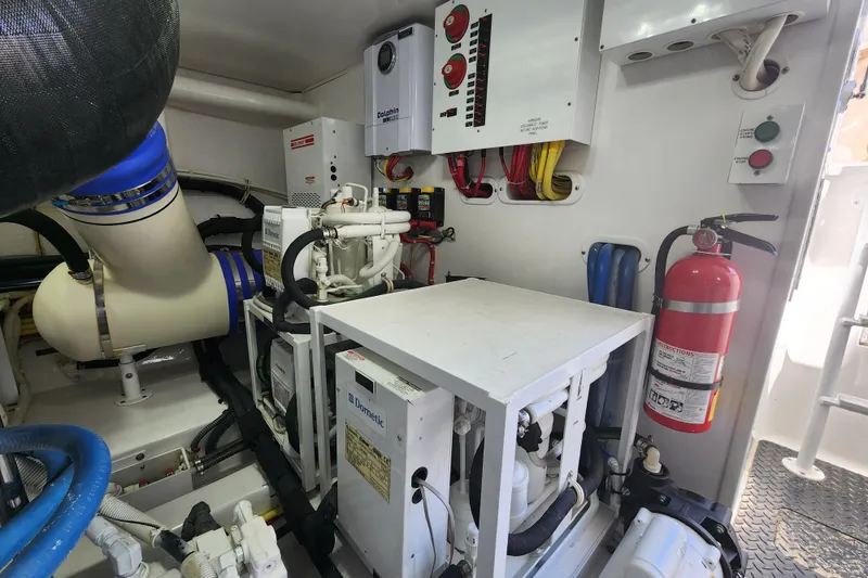 Slide: The Image of Engine room of 2018 Viking 48 Sport Tower with equipment and fire extinguisher. - 145