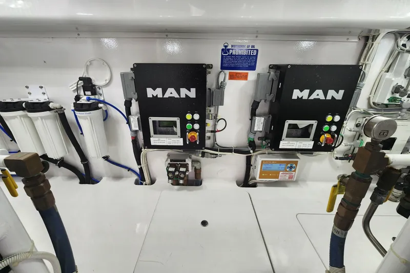 Slide: The Image of Engine room of 2018 Viking 48 Sport Tower with MAN control panels and filtration system. - 148