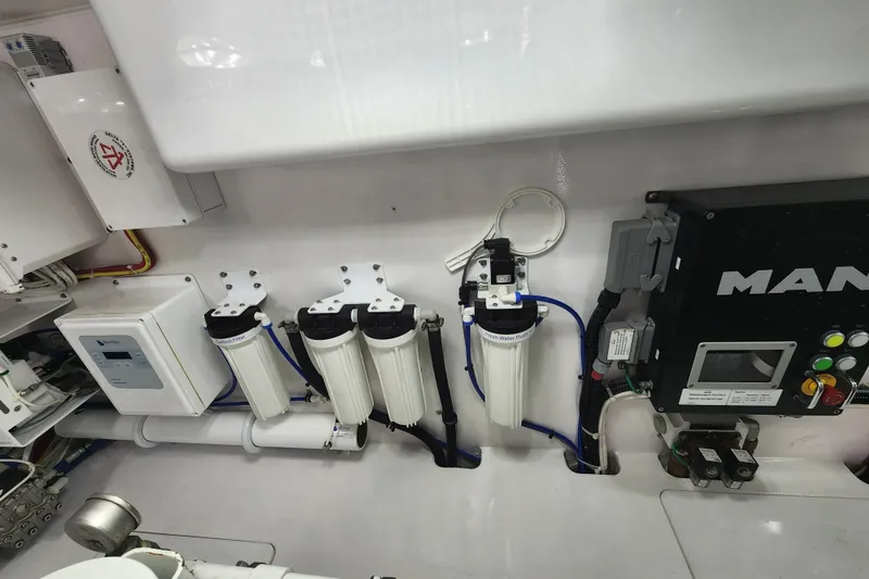 Slide: The Image of Engine room of 2018 Viking 48 Sport Tower with filtration system and control panel. - 150