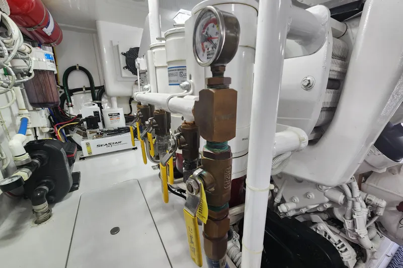 Slide: The Image of Engine room of 2018 Viking 48 Sport Tower with mechanical components and gauges. - 152