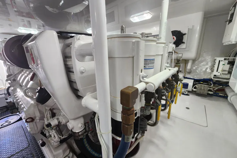 Slide: The Image of Engine room of 2018 Viking 48 Sport Tower yacht, showcasing mechanical components and systems. - 153