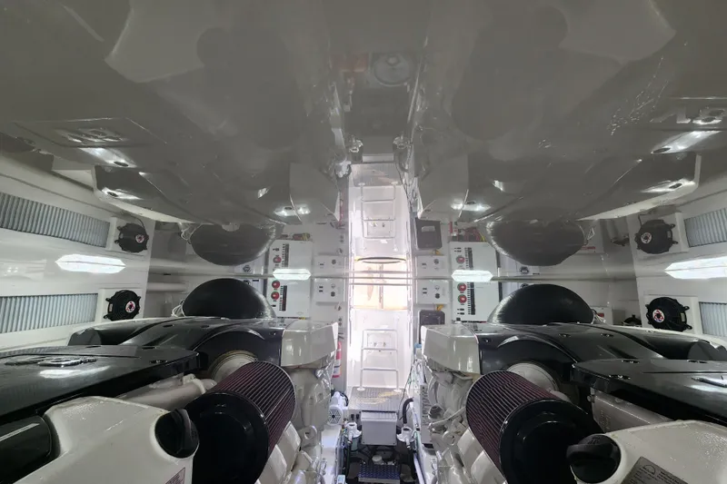 Slide: The Image of Engine room of 2018 Viking 48 Sport Tower, showcasing dual engines and control panels. - 155