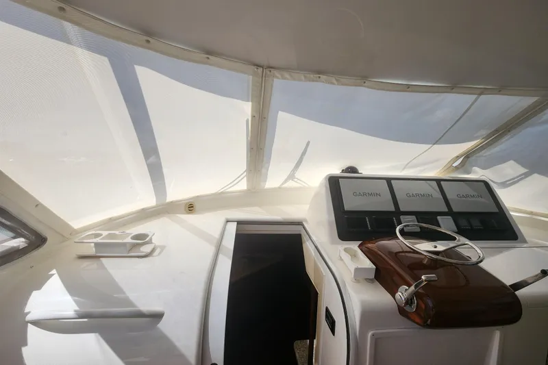 Slide: The Image of Interior view of 2018 Viking 48 Sport Tower helm with Garmin navigation displays. - 18