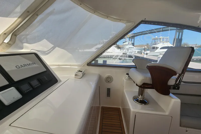 Slide: The Image of Interior of 2018 Viking 48 Sport Tower with Garmin navigation system and captain's chair. - 20
