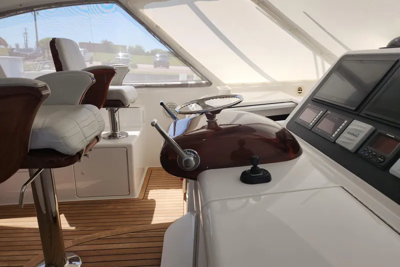 Slide: The Image of Interior helm of 2018 Viking 48 Sport Tower with modern controls and seating. - 22