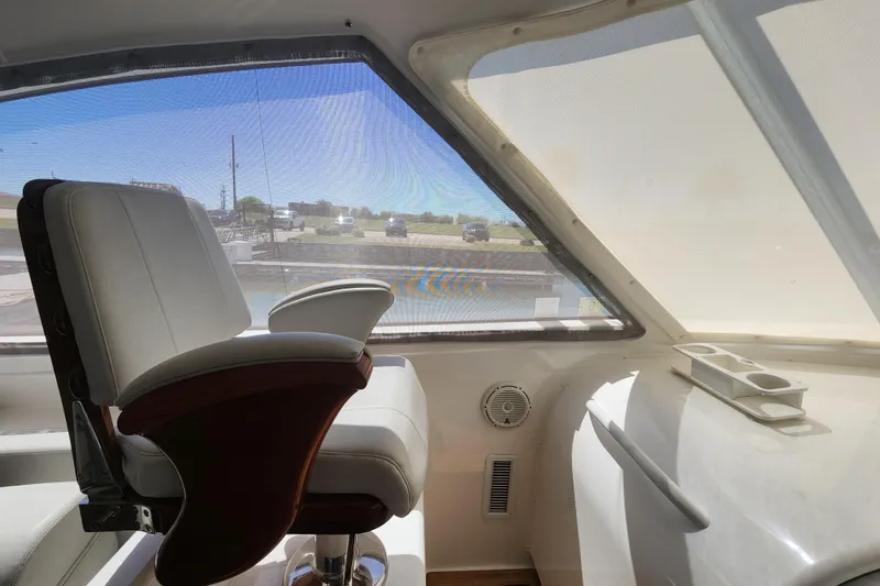 Slide: The Image of Interior view of 2018 Viking 48 Sport Tower with captain's chair and window. - 25
