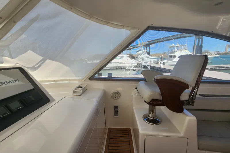 Slide: The Image of Interior view of 2018 Viking 48 Sport Tower yacht helm with captain's chair and Garmin display. - 26