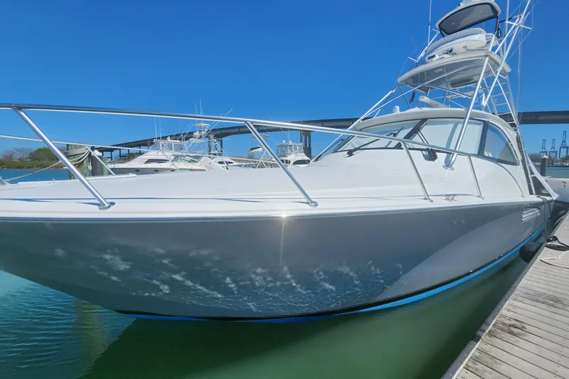 Slide: The Image of 2018 Viking 48 Sport Tower yacht docked under clear blue sky. - 3