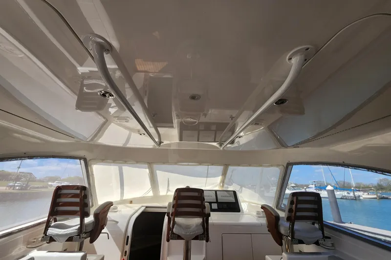 Slide: The Image of Interior view of 2018 Viking 48 Sport Tower yacht with helm and seating. - 32