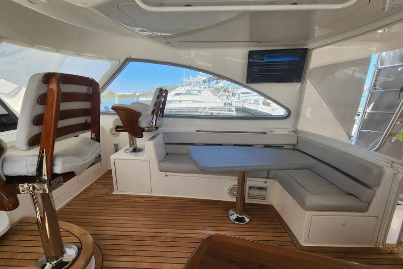 Slide: The Image of Luxurious interior of 2018 Viking 48 Sport Tower yacht with seating and wooden flooring. - 33