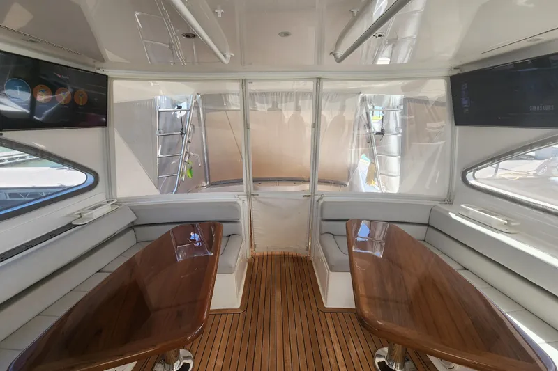 Slide: The Image of Interior of 2018 Viking 48 Sport Tower yacht with wooden tables and plush seating. - 37