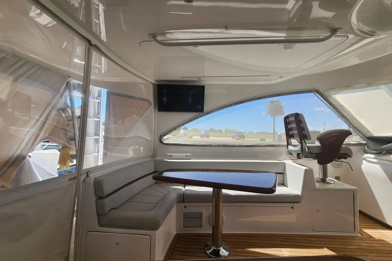Slide: The Image of Interior of 2018 Viking 48 Sport Tower with seating, table, and helm chair. - 39