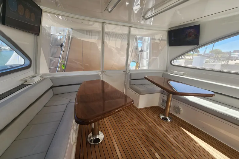 Slide: The Image of Luxurious interior of 2018 Viking 48 Sport Tower with wooden flooring and seating. - 40