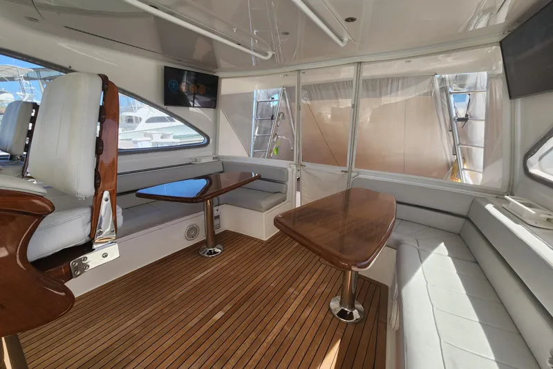 Slide: The Image of Luxurious interior of 2018 Viking 48 Sport Tower yacht with wooden flooring and seating. - 41