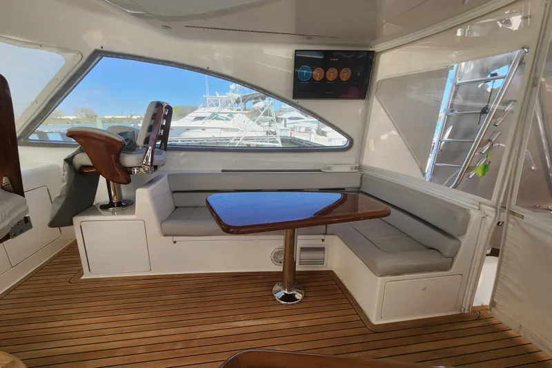 Slide: The Image of Luxurious interior of 2018 Viking 48 Sport Tower yacht with seating and wooden table. - 42