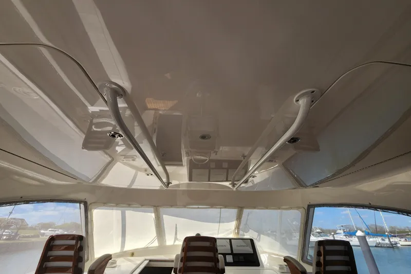 Slide: The Image of Interior view of 2018 Viking 48 Sport Tower yacht with helm and seating. - 47